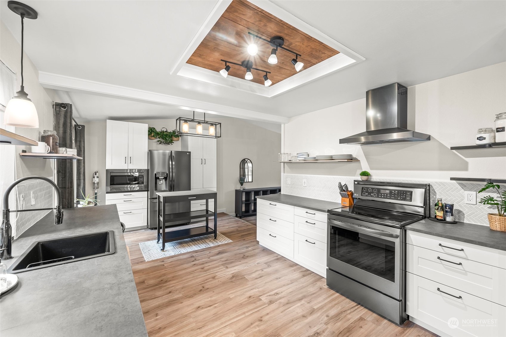 66 Bonney Street Steilacoom, WA 98388 - Photo 12 of 40 a kitchen with granite countertop a stove and a refrigerator