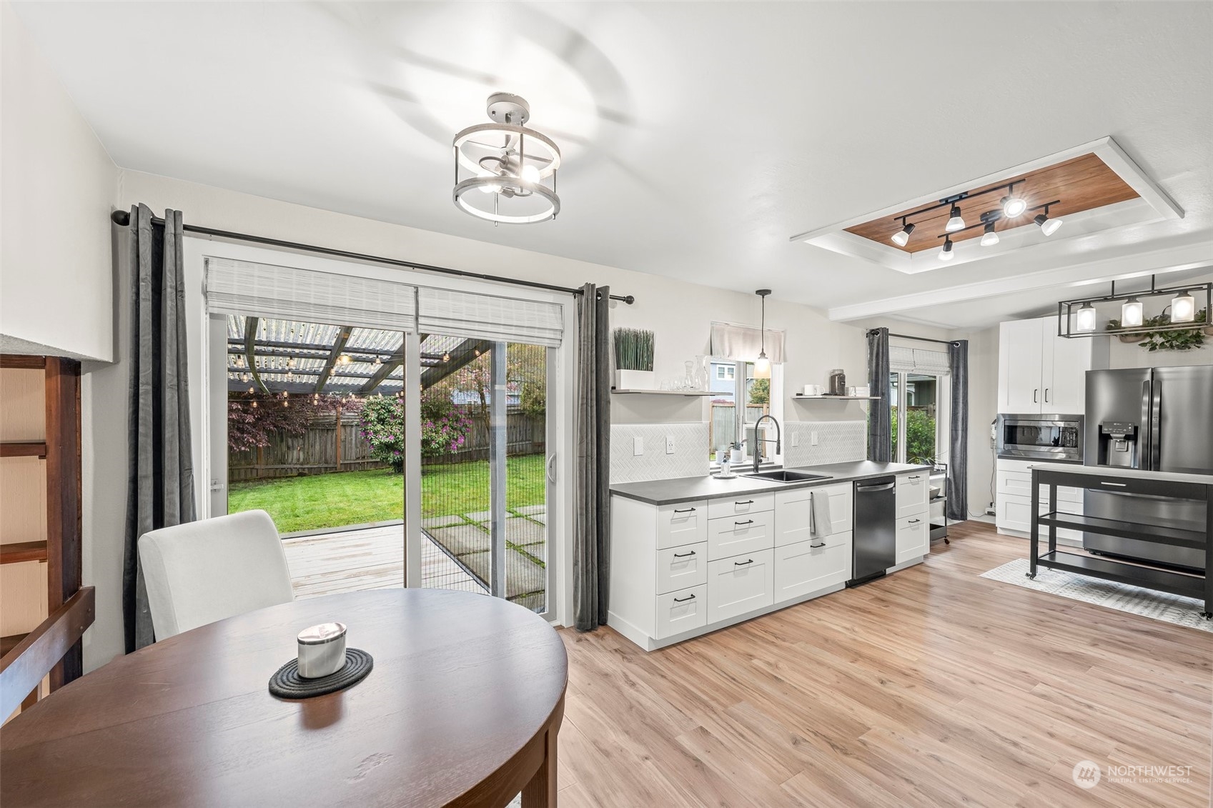 66 Bonney Street Steilacoom, WA 98388 - Photo 15 of 40 a kitchen with a table chairs refrigerator and sink