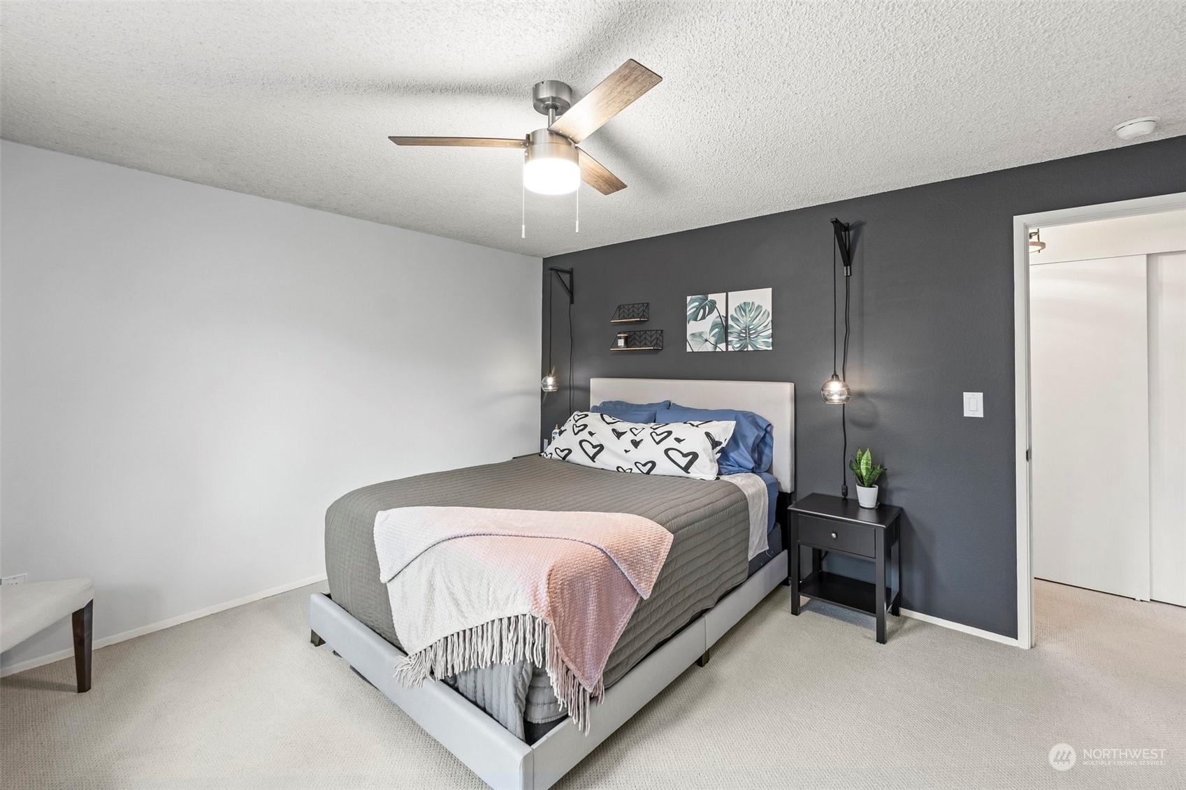 66 Bonney Street Steilacoom, WA 98388 - Photo 23 of 40 a bedroom with a bed and a chandelier