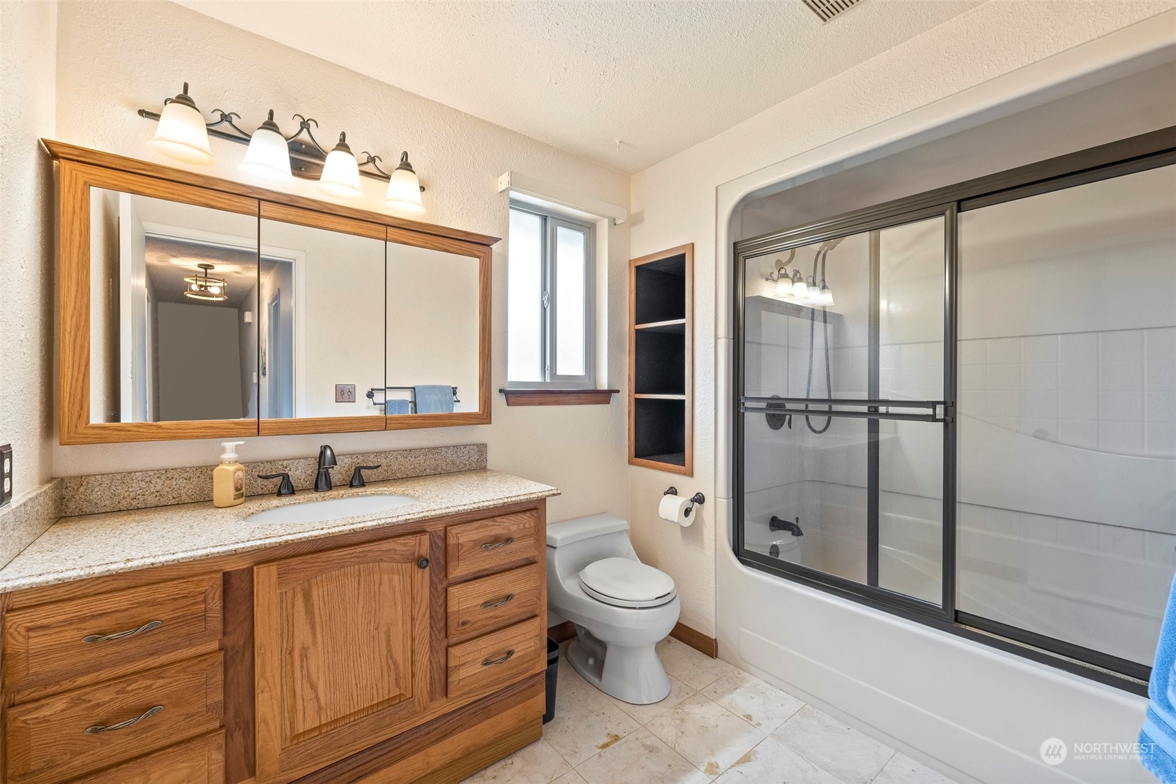 66 Bonney Street Steilacoom, WA 98388 - Photo 29 of 40 a spacious bathroom with a double vanity sink toilet mirror and shower