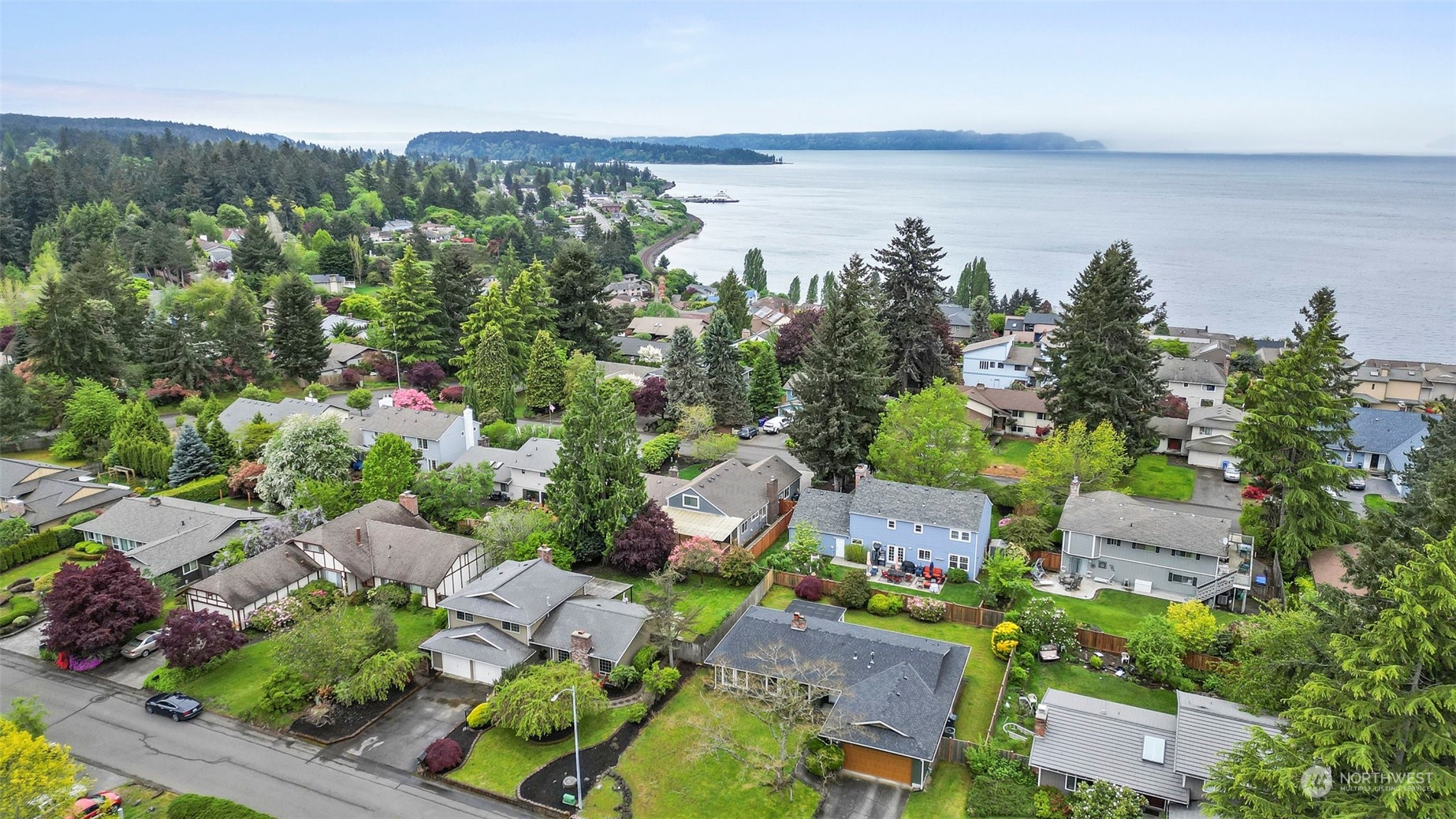 66 Bonney Street Steilacoom, WA 98388 - Photo 3 of 40 an aerial view of a city with lots of residential buildings ocean and mountain view in back