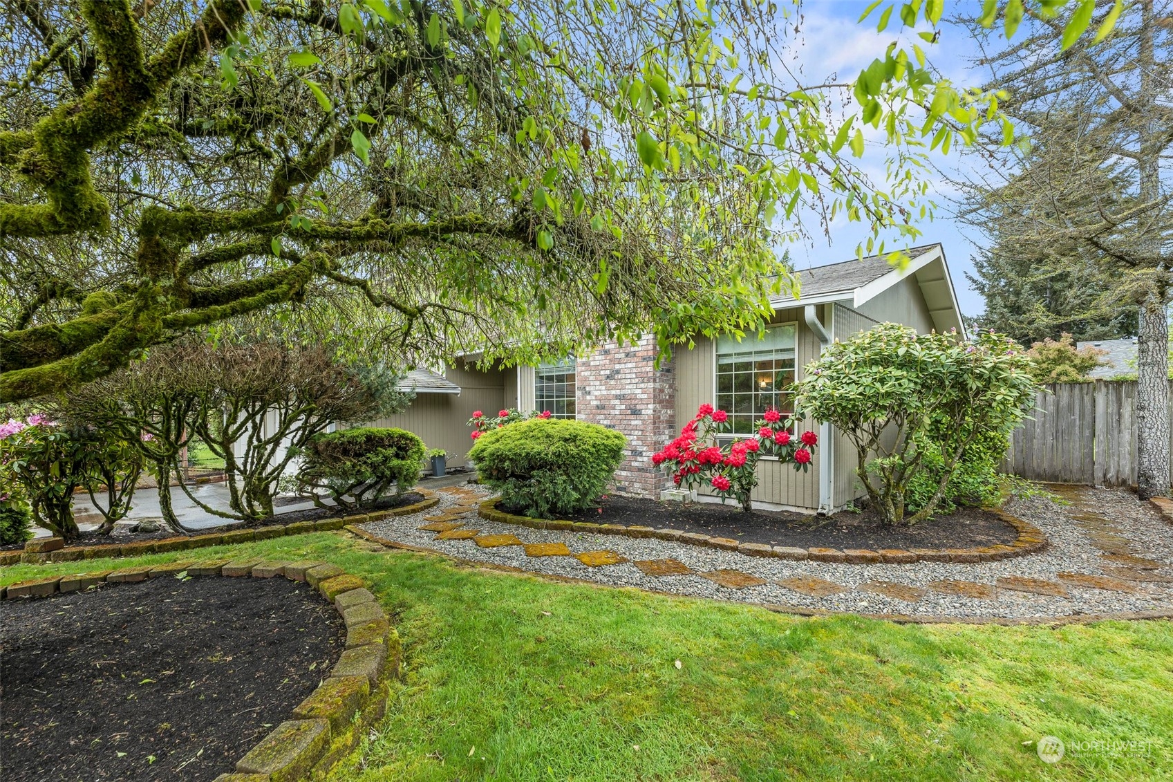 66 Bonney Street Steilacoom, WA 98388 - Photo 32 of 40 a view of a white house with a yard and plants