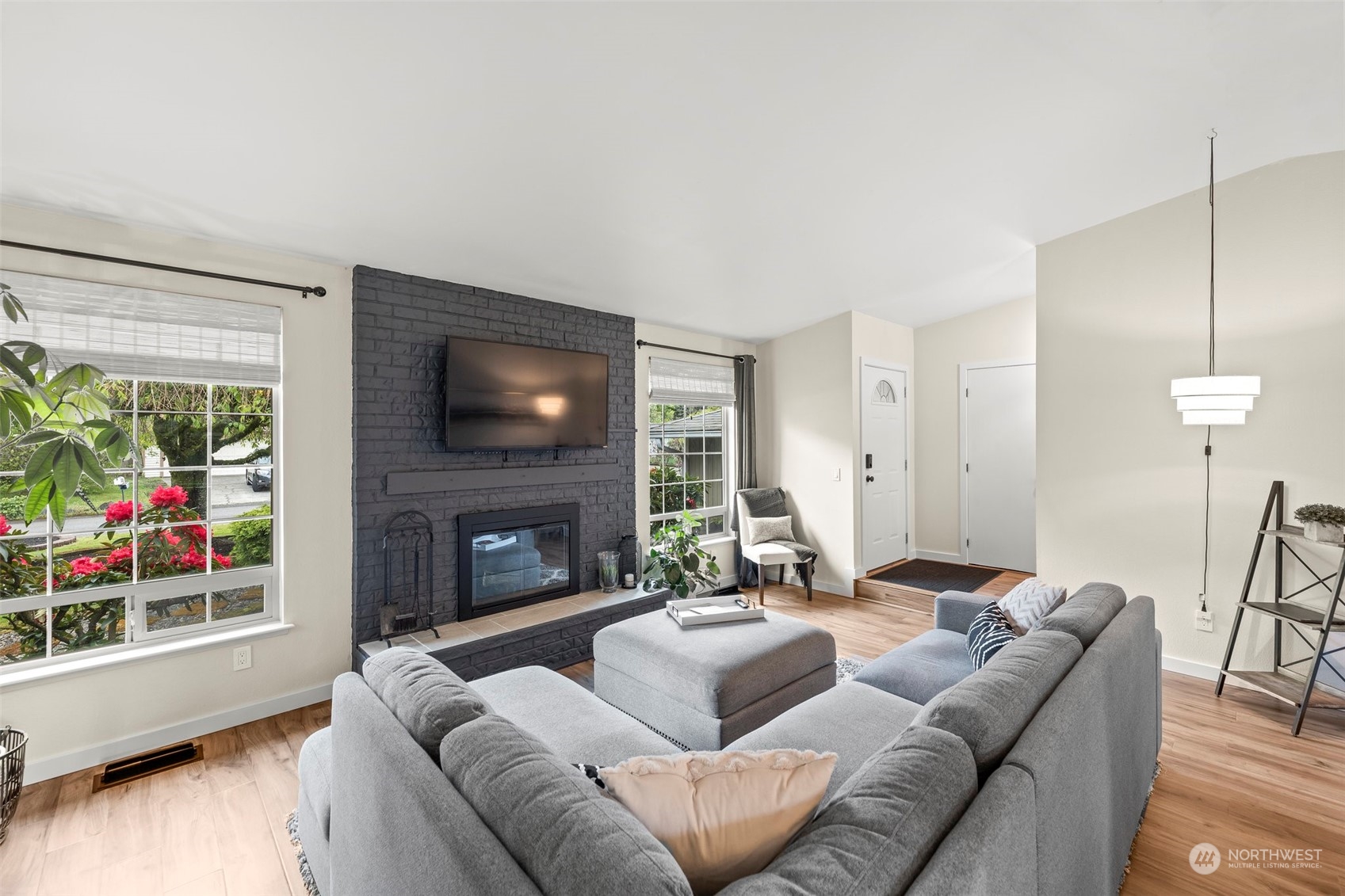 66 Bonney Street Steilacoom, WA 98388 - Photo 7 of 40 a living room with furniture a fireplace and a flat screen tv
