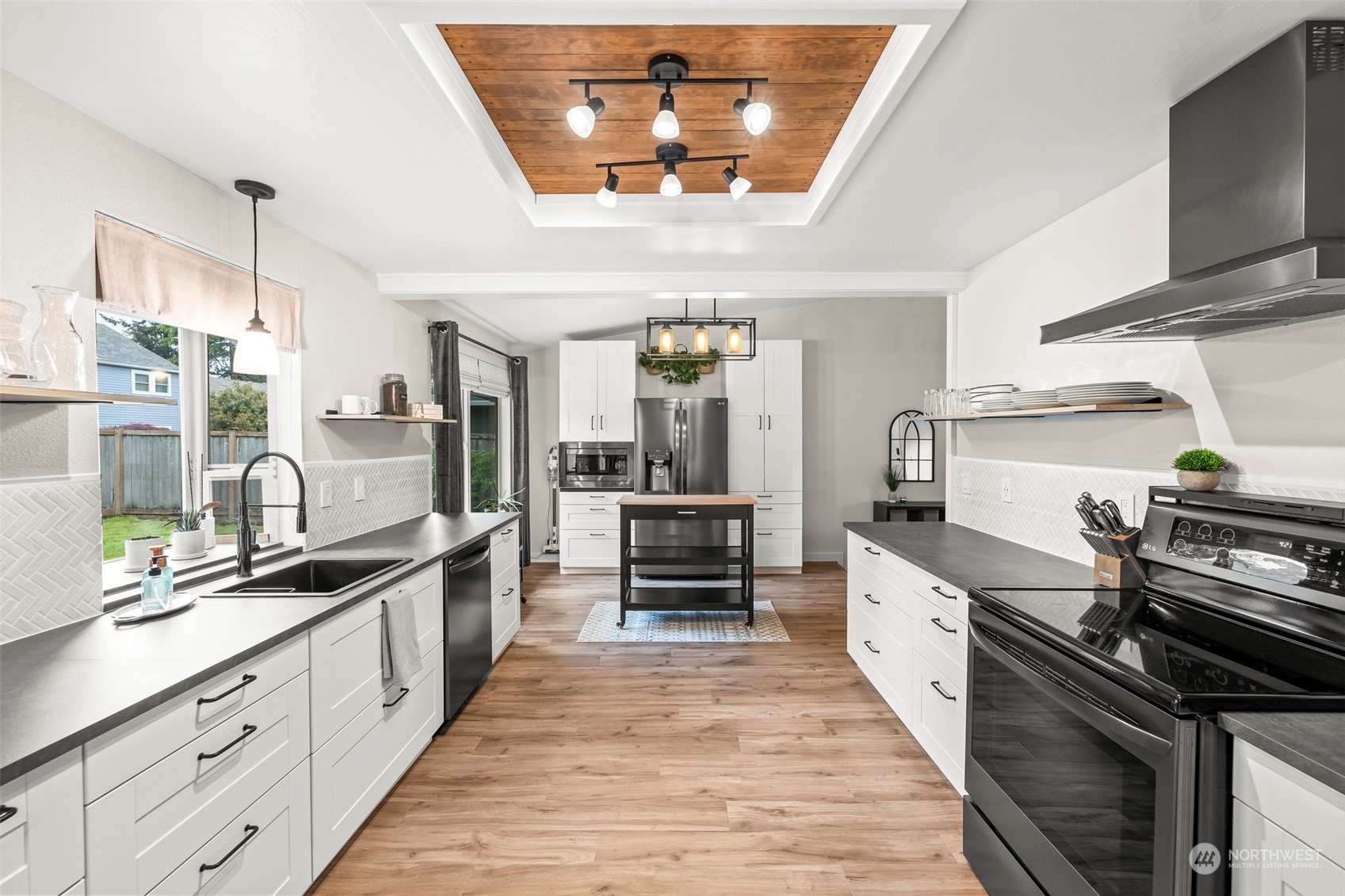 66 Bonney Street Steilacoom, WA 98388 - Photo 10 of 40 a large kitchen with stainless steel appliances a stove and a wooden floors
