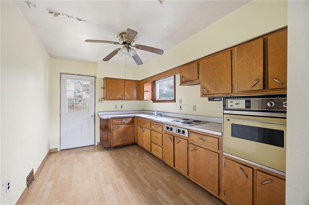 105 Pine Street Trafford, PA 15085 - Photo 11 of 22 a kitchen with stainless steel appliances granite countertop a stove and a refrigerator