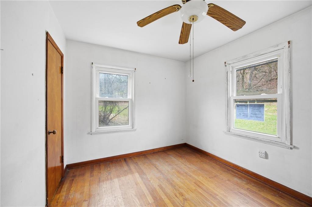 105 Pine Street Trafford, PA 15085 - Photo 15 of 22 a view of an empty room with wooden floor and a window