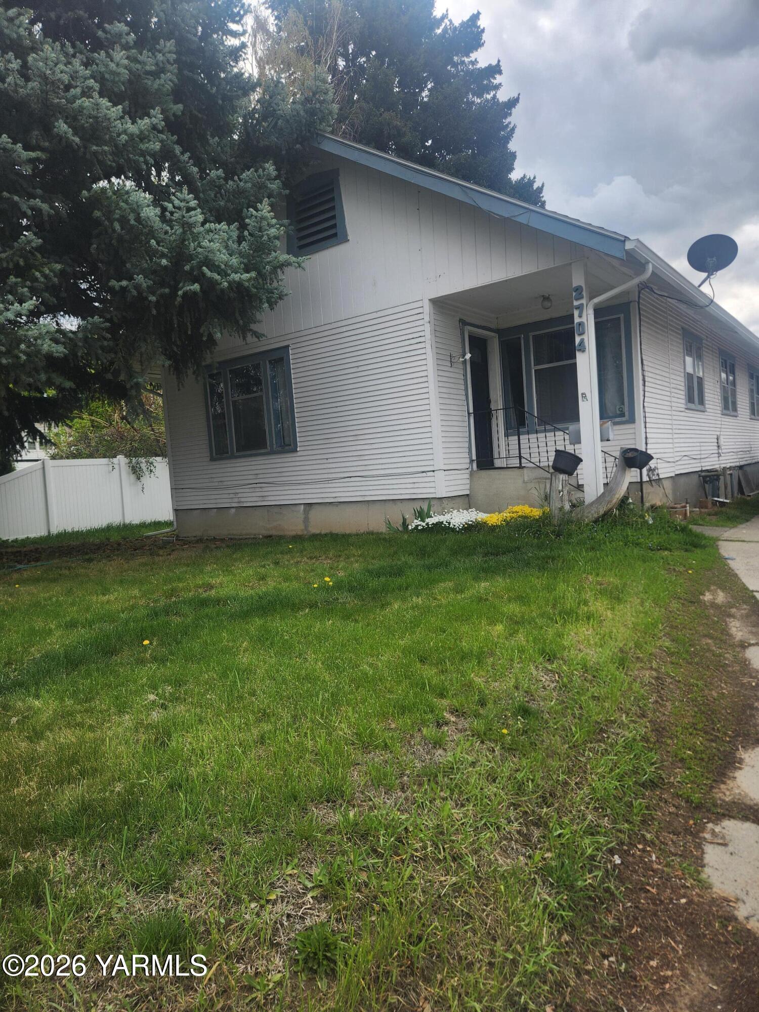 2704 Summitview Avenue Yakima, WA 98902 - Photo 1 of 13 a front view of a house with a garden and yard