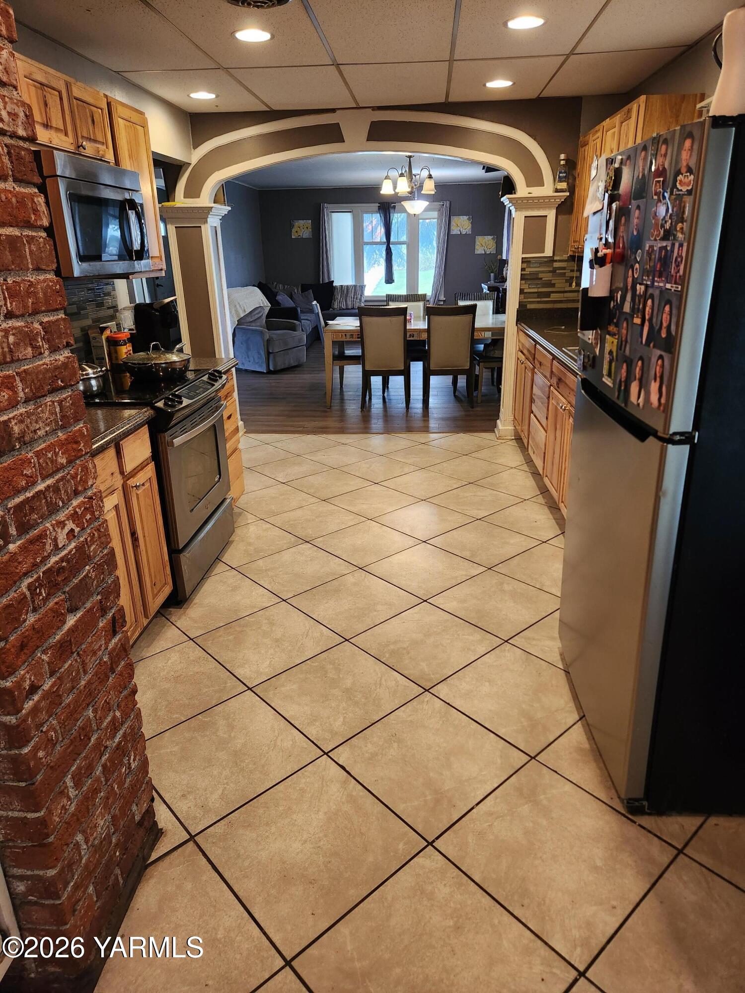 2704 Summitview Avenue Yakima, WA 98902 - Photo 7 of 13 a kitchen with stainless steel appliances granite countertop a refrigerator and a stove top oven