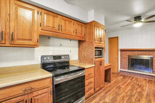 a kitchen with stainless steel appliances granite countertop a stove and a refrigerator