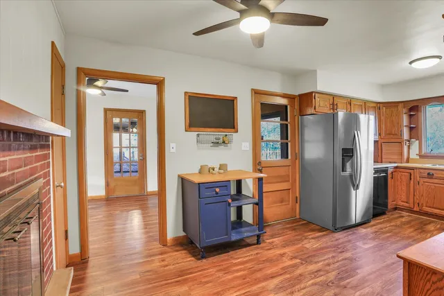 a view of kitchen with stainless steel appliances granite countertop cabinets and wooden floor