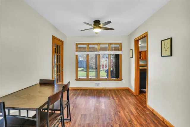 a view of a livingroom with wooden floor and a ceiling fan
