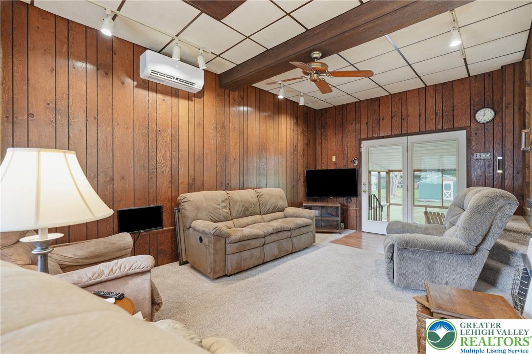 1385 Woodmere Road Pottstown, PA 19464 - Photo 17 of 57 A relaxed living space with warm wood paneling and direct outdoor access invites comfortable everyday living.