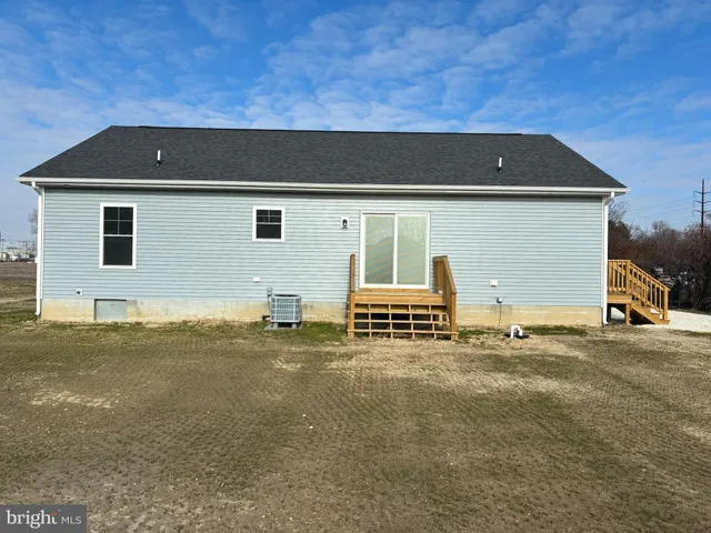 a backyard of a house with barbeque oven and garage