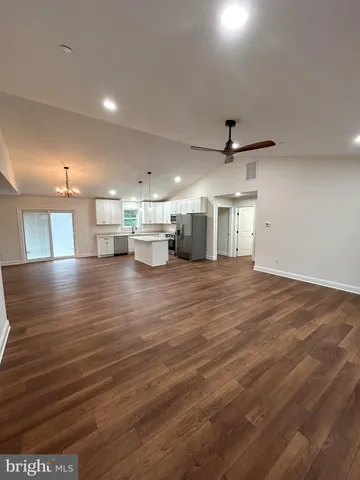 a view of a room with wooden floor