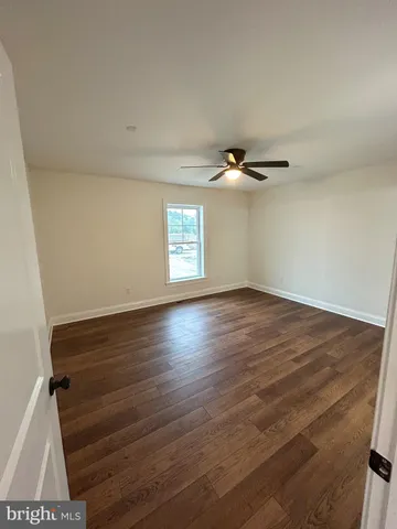 a view of a room with wooden floor and window