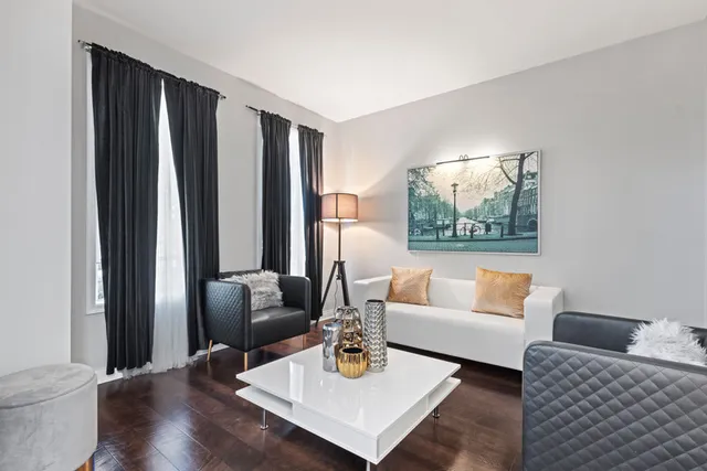 a view of a livingroom with workspace and a window