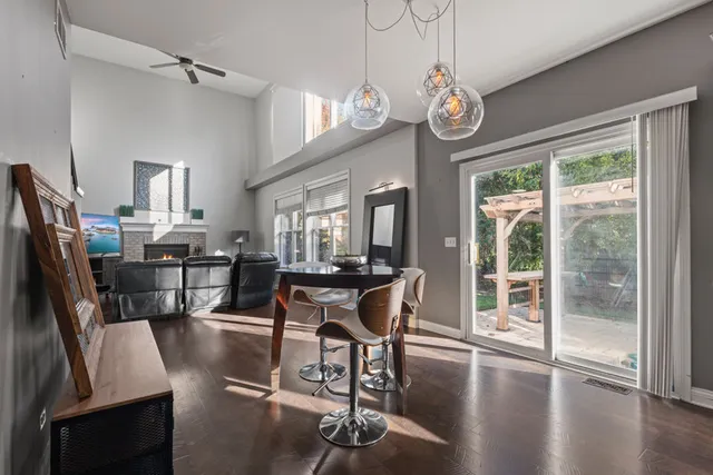 a view of a dining room with furniture large window and wooden floor