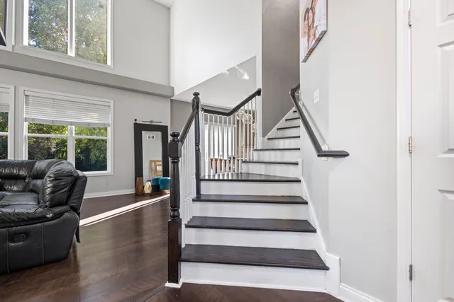 a bedroom with a bed and large windows