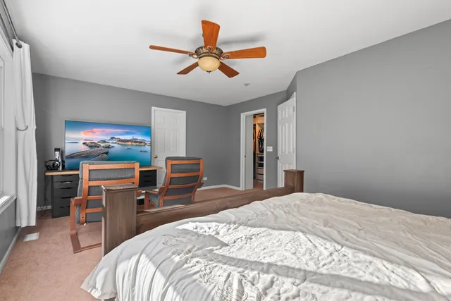 a spacious bedroom with a bed and a window