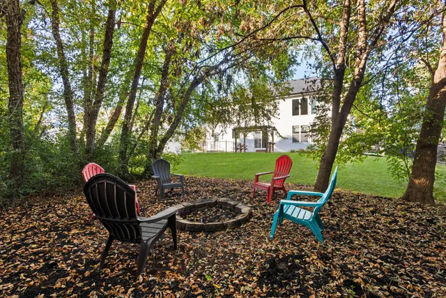 a backyard of a house with table and chairs