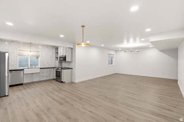 870 North Ada Loop Lehi, UT 84048 - Photo 39 of 51 Open-concept living space with wood-finish flooring, recessed lighting, and a modern kitchen