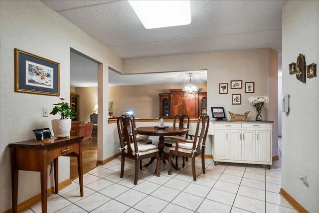 a dining hall with granite countertop a dining table and chairs