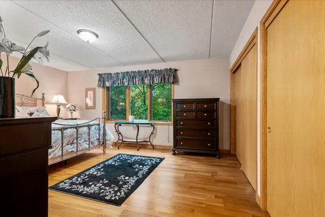 a view of room with wooden floor and furniture