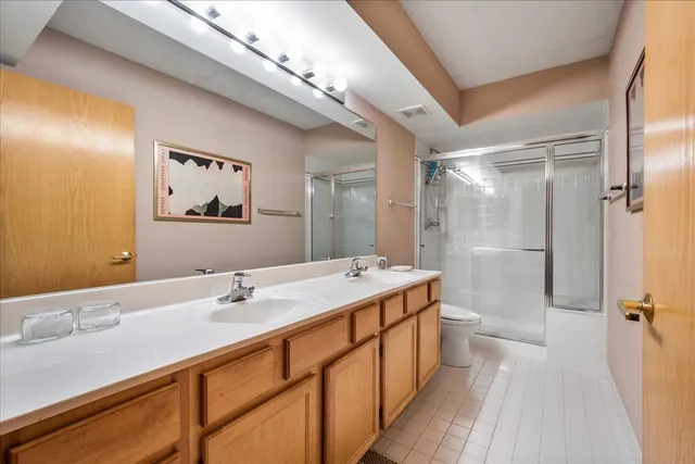 a bathroom with a double vanity sink mirror double and shower