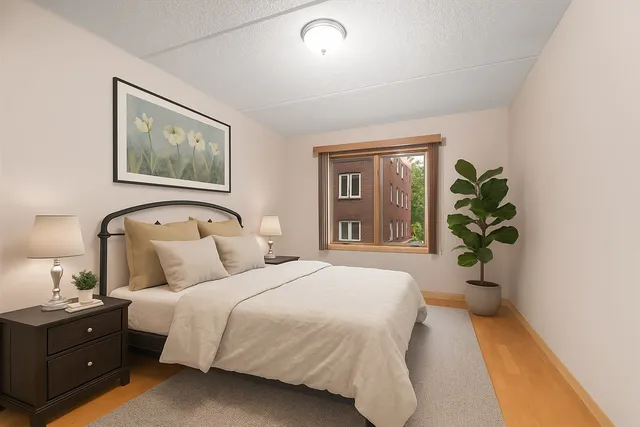 a bedroom with a bed and a window