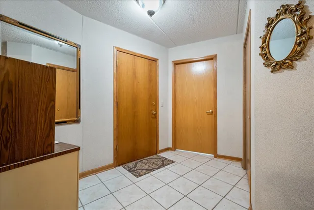 a view of a bathroom with mirror and window