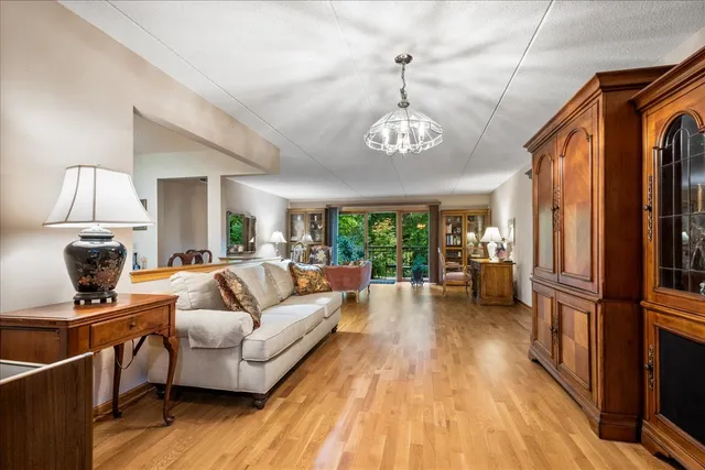 a living room with furniture and a chandelier