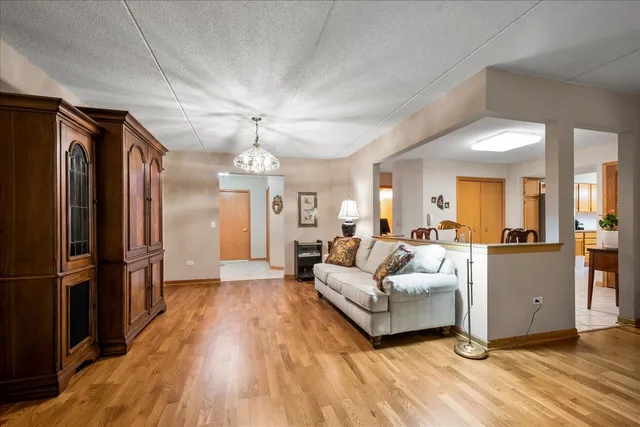 a living room with furniture and a chandelier