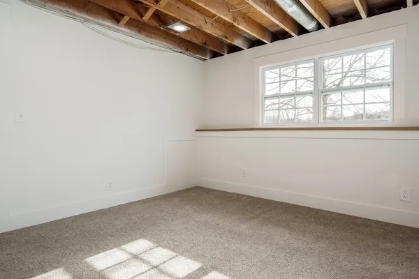 an empty room with a empty space and windows