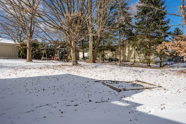 a view of a yard with snow on the road