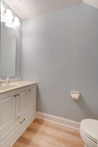 a bathroom with a sink a toilet a vanity and mirror