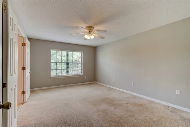 a view of room with a ceiling fan and window