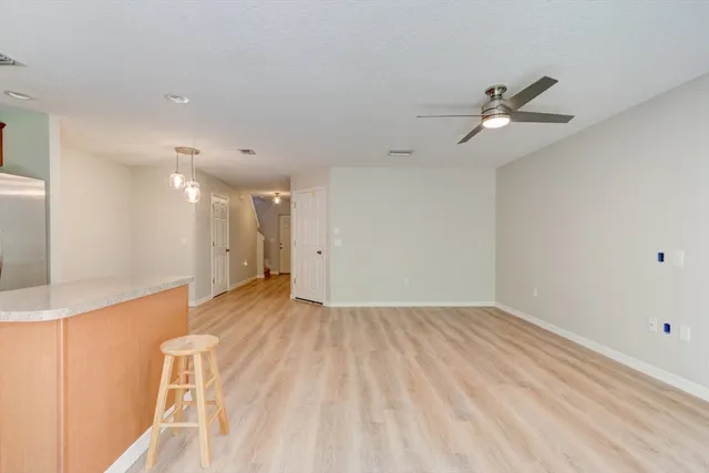 a view of empty room with a ceiling fan