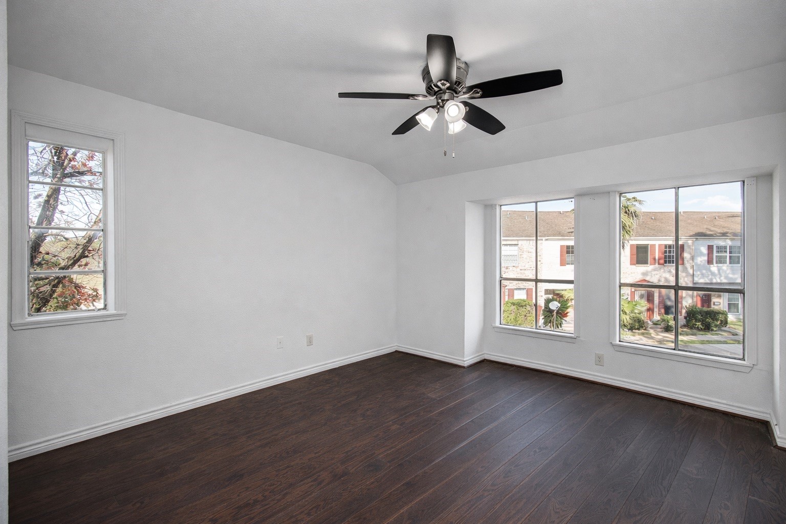 7902 Grove Ridge Drive Houston, TX 77061 - Photo 11 of 16 a view of an empty room with wooden floor and a window