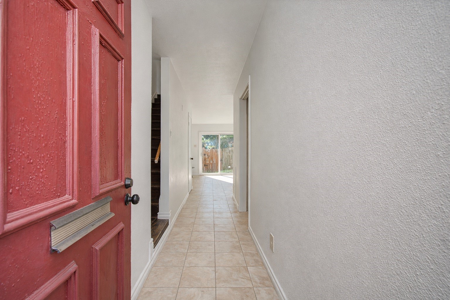 7902 Grove Ridge Drive Houston, TX 77061 - Photo 3 of 16 a view of a hallway with wooden floor and staircase