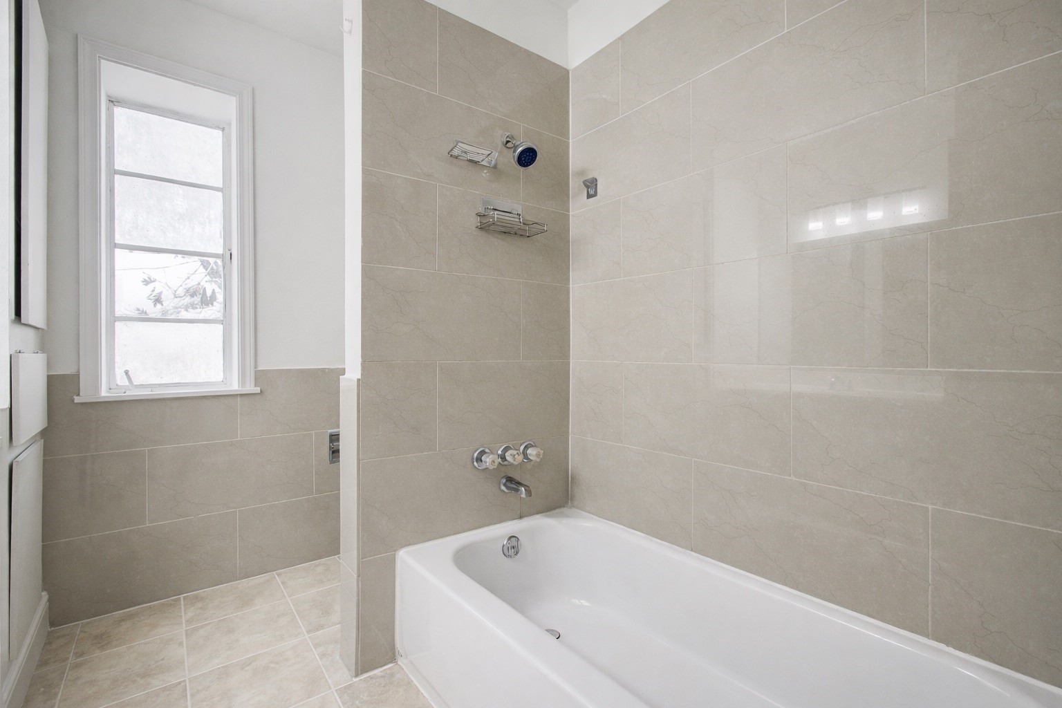 7902 Grove Ridge Drive Houston, TX 77061 - Photo 9 of 16 a white bath tub sitting next to a window