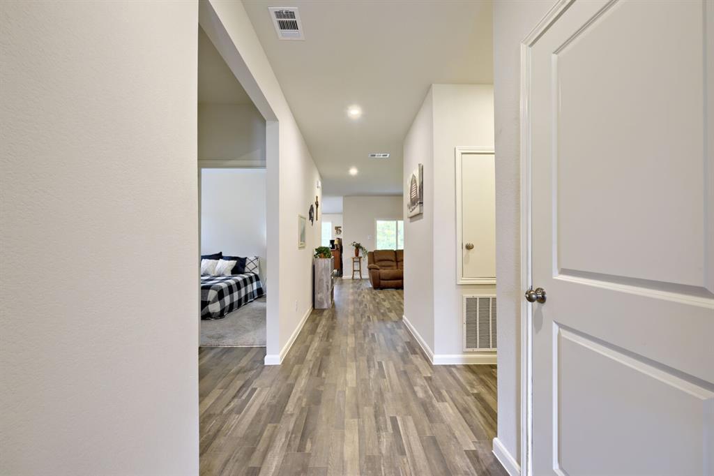 420 Jameson Springtown, TX 76082 - Photo 24 of 29 a view of a hallway with wooden floor fireplace and living room