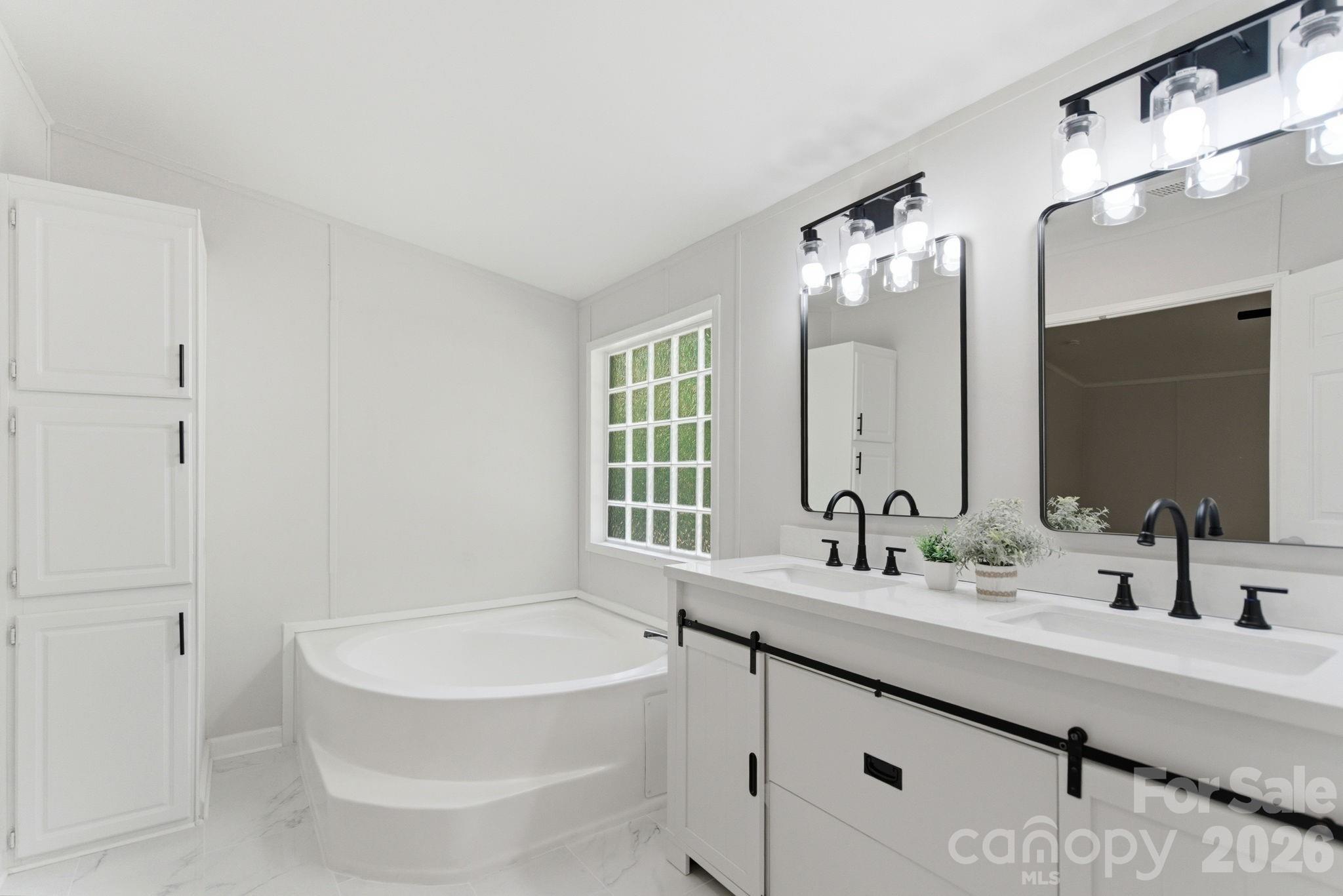 481 Harrell Road Burgaw, NC 28425 - Photo 13 of 25 a bathroom with a double vanity sink mirror and bathtub