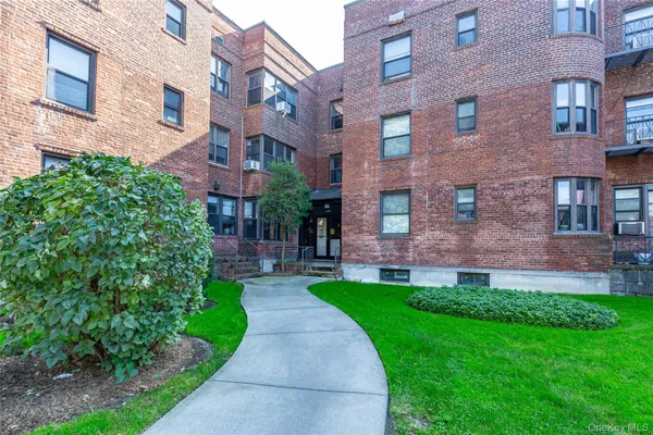 a view of a brick building with a yard