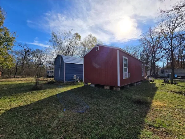 a view of a backyard with large trees