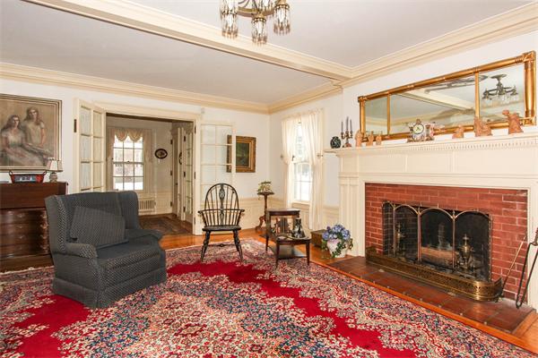 272 Longhill Street Springfield, MA 01108 - Photo 8 of 30 a living room with furniture a flat screen tv and a fireplace