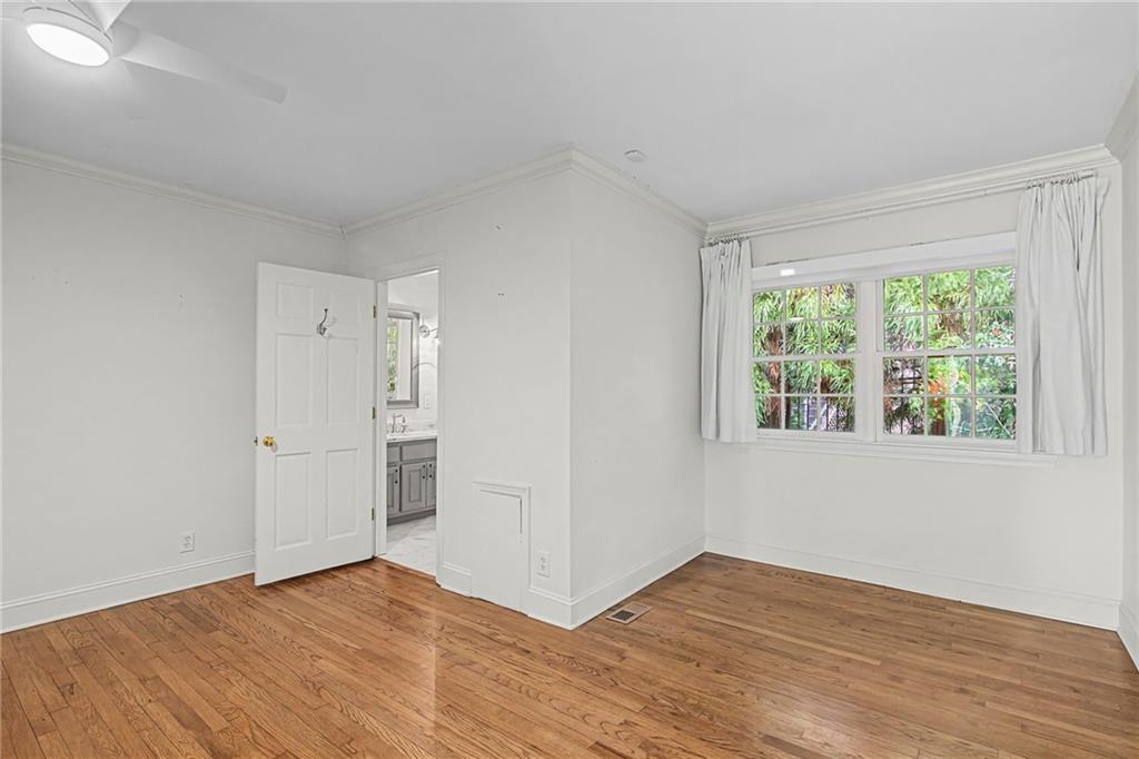 3819 North Stratford Road Northeast Atlanta, GA 30342 - Photo 21 of 48 a view of an empty room with wooden floor and a window