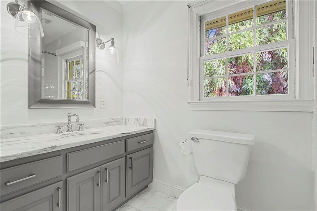 3819 North Stratford Road Northeast Atlanta, GA 30342 - Photo 22 of 48 a bathroom with a toilet sink and mirror