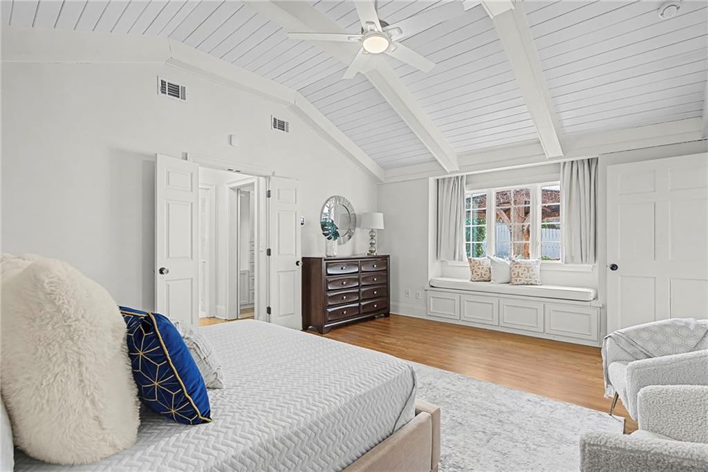 3819 North Stratford Road Northeast Atlanta, GA 30342 - Photo 27 of 48 a spacious bedroom with a bed and a couch