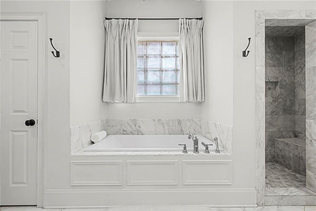 3819 North Stratford Road Northeast Atlanta, GA 30342 - Photo 29 of 48 a white bath tub sitting next to a shower