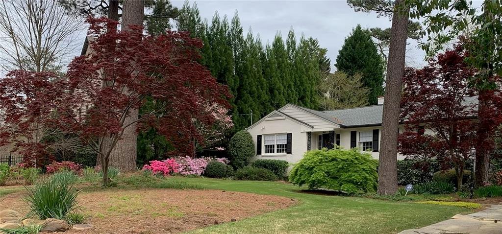 3819 North Stratford Road Northeast Atlanta, GA 30342 - Photo 42 of 48 a front view of a house with a yard and trees